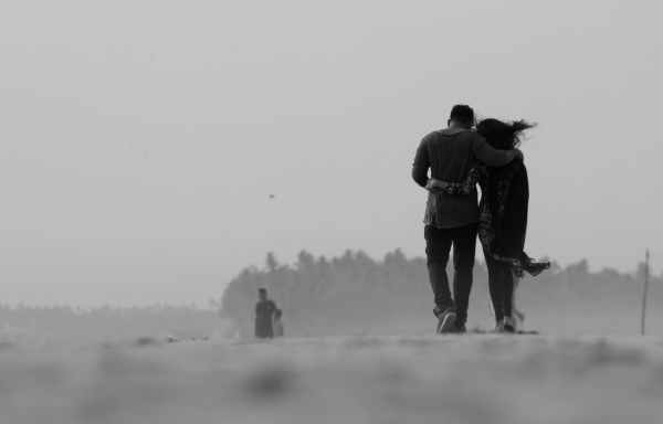 grayscale photography of couple walking on ground