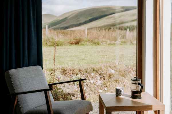 coffee press near mug on table in countryside house